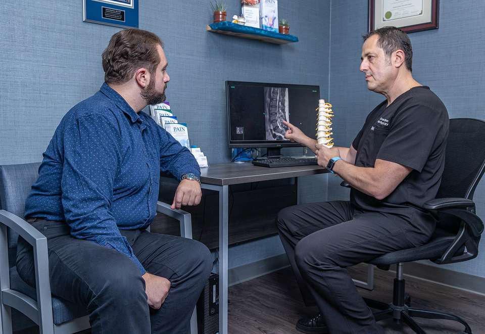 Stem Cell Therapy | Doctor Diagnosing Spinal Pain Cause